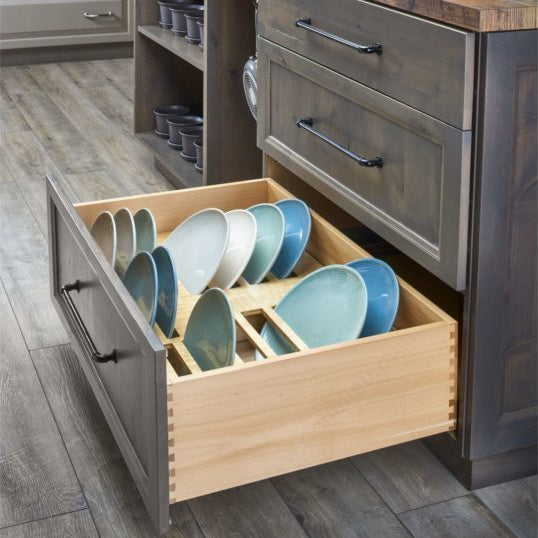 Kitchen drawer with organized dishes in a modern kitchen setting